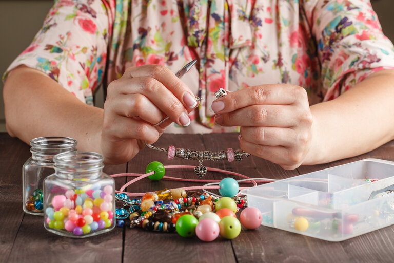 Relax hobby. Female make craft beads at home